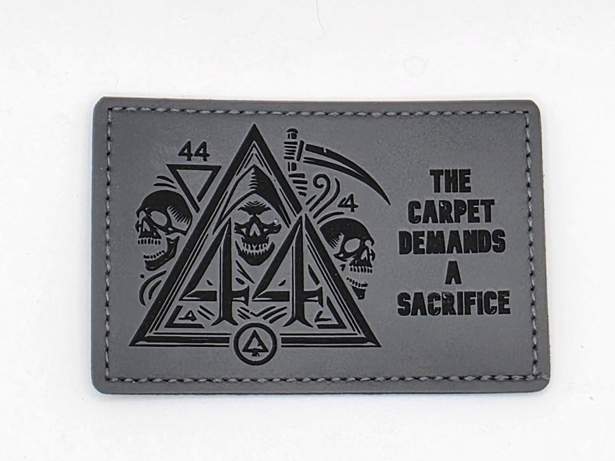 Gray and black patch: The Carpet Demands a Sacrifice